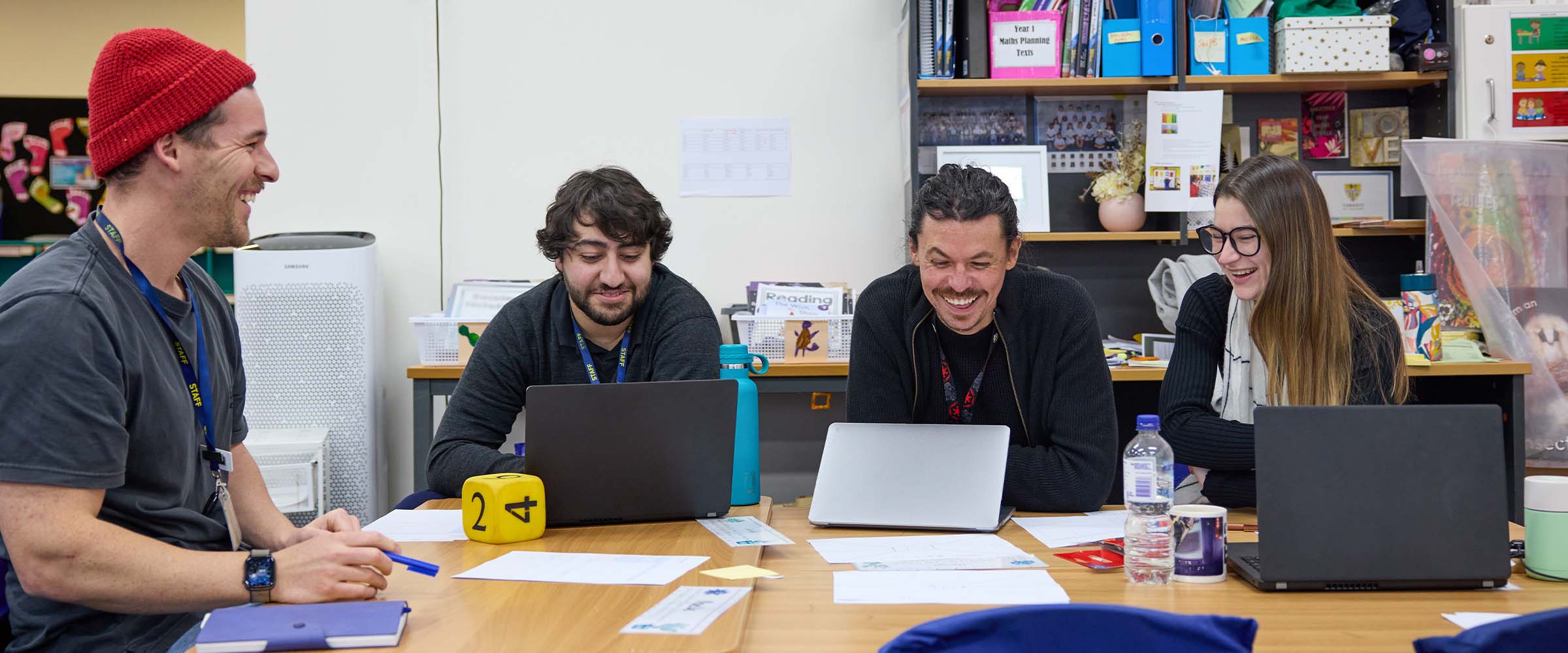 Group of school staff collaborating in a staffroom to plan their journey as a Be You Learning Community.
