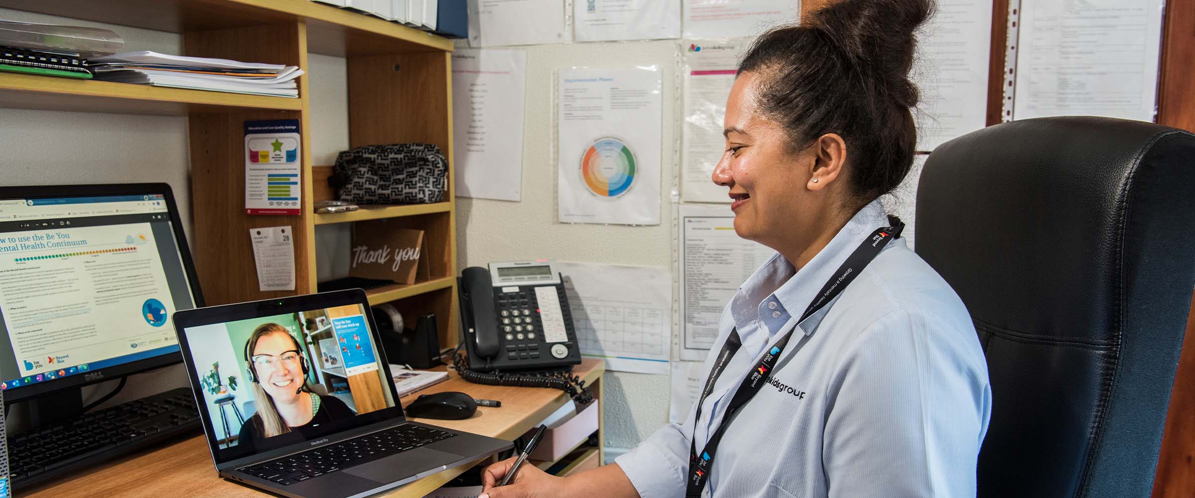 Educator helping students with an active wellbeing exercise as part of implementation support.