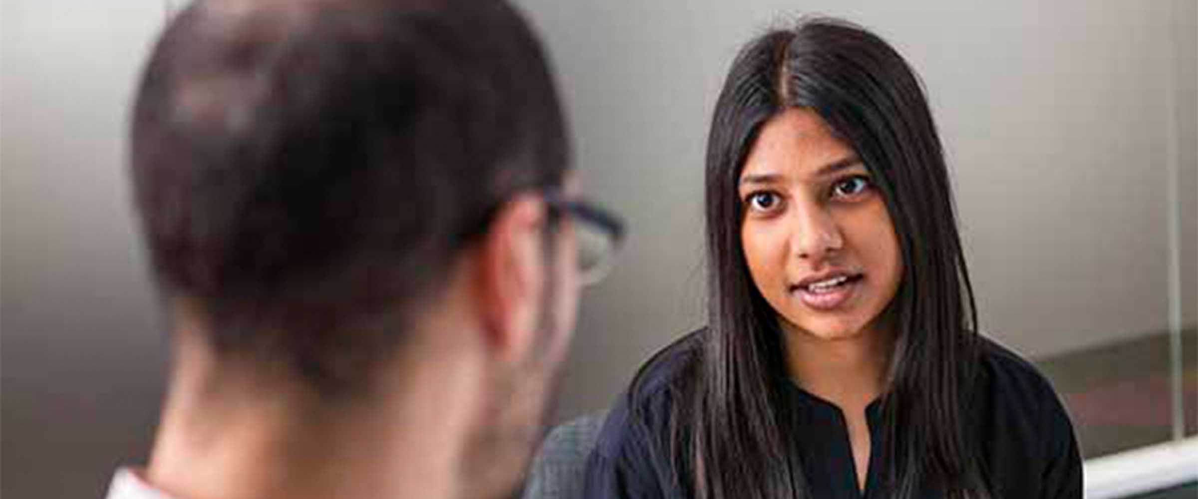 University lecturers discussing mental health promotion resources designed for tertiary professionals.