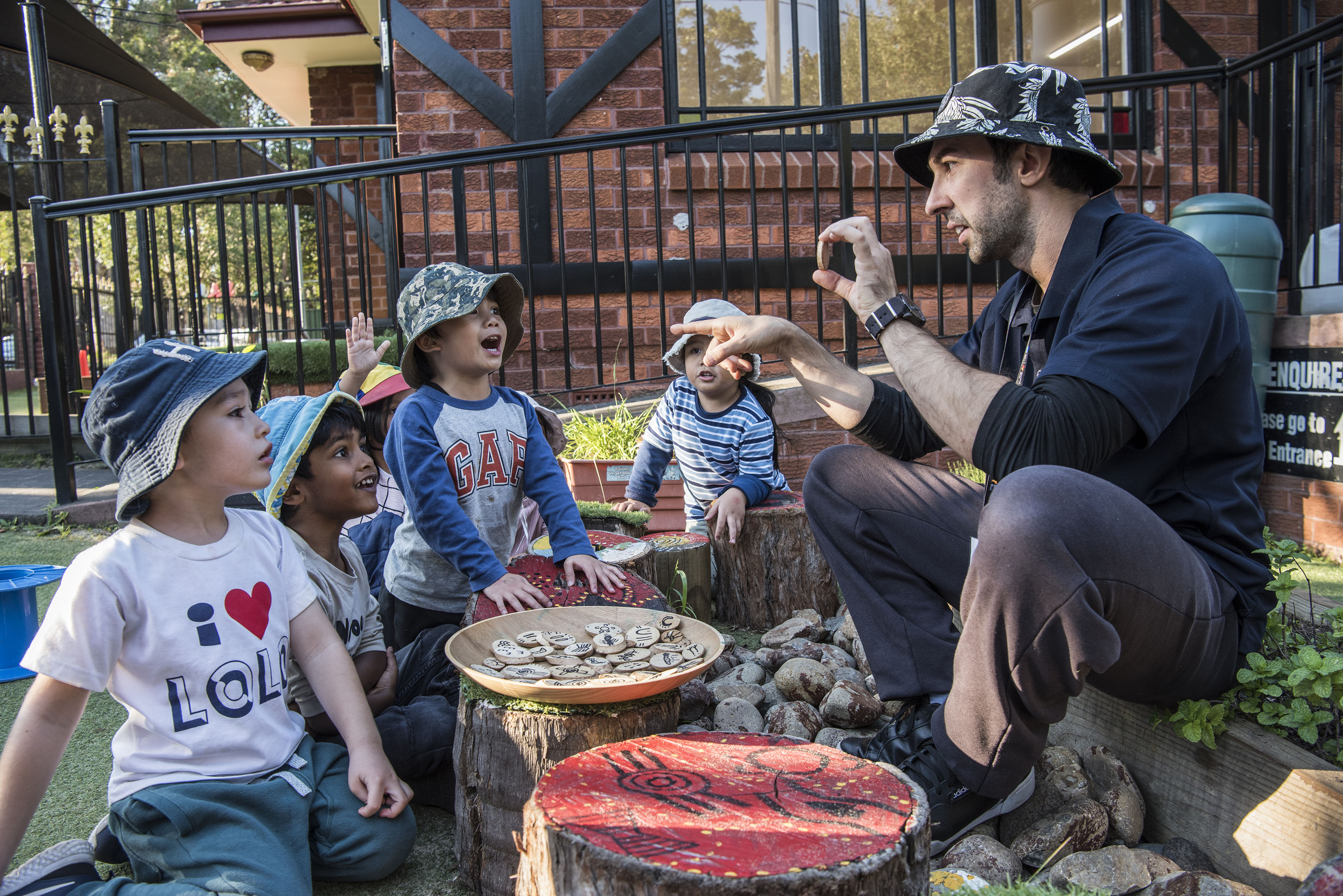 A group of young children engaged in an outdoor lesson with an adult